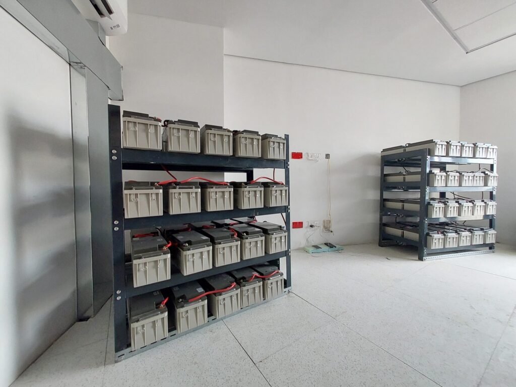 Battery room with battery banks racked on steel shelving
