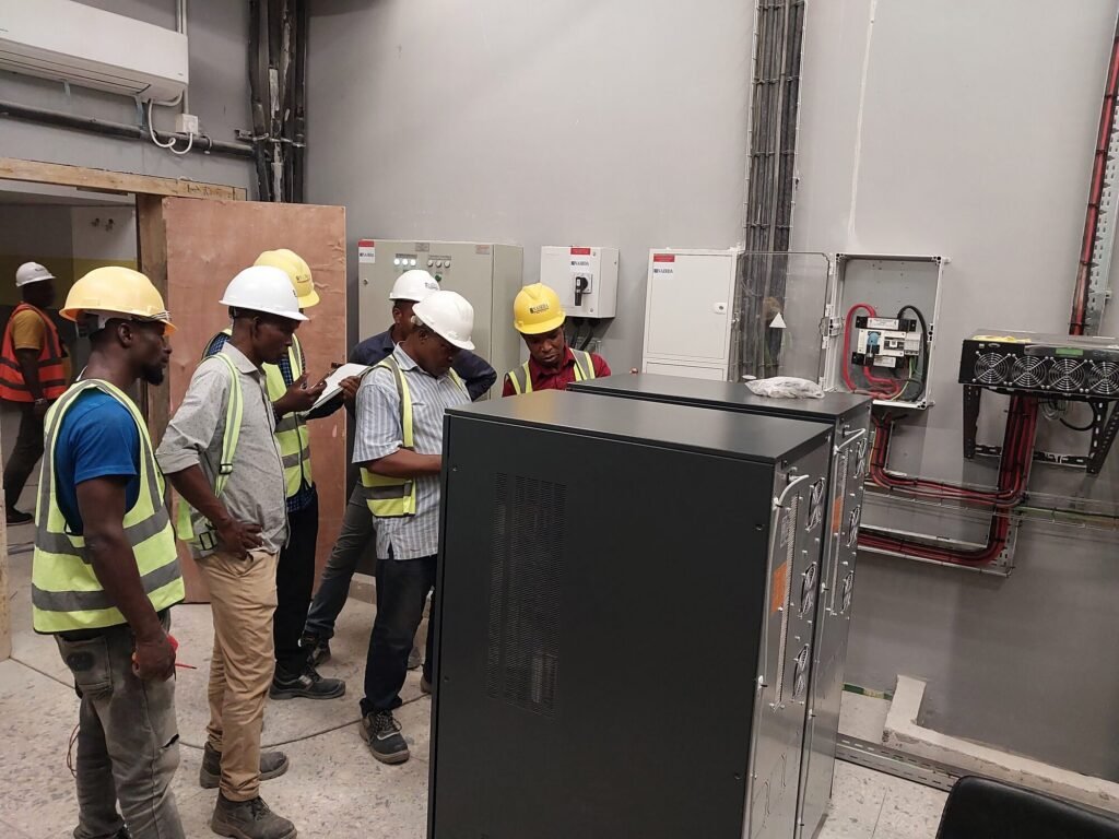 Site team beside the plant room enclosure and switchgear