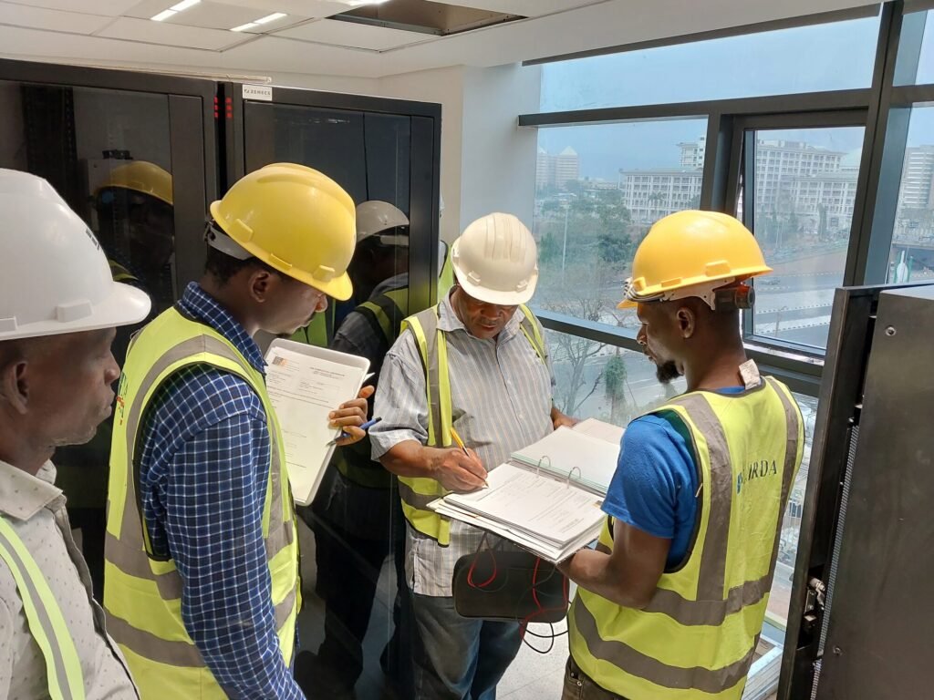 Engineers reviewing drawings on site in hi-vis and hard hats