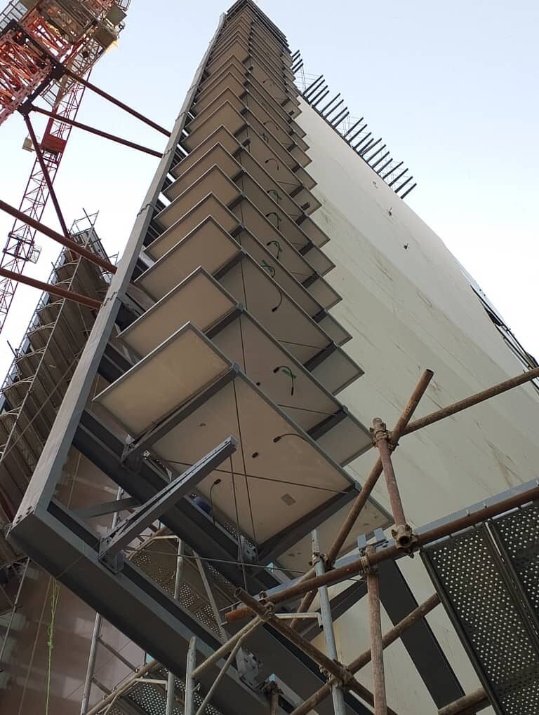 The completed run of panels on the tower facade, seen from below