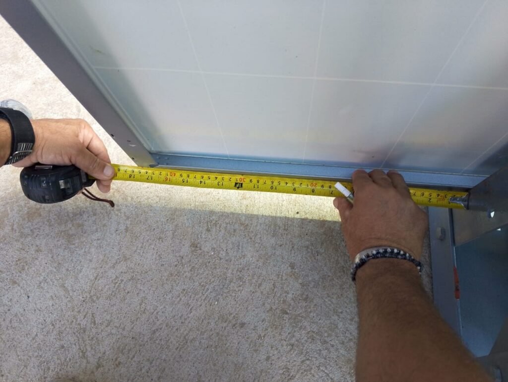 Measuring a panel frame with a tape before installation