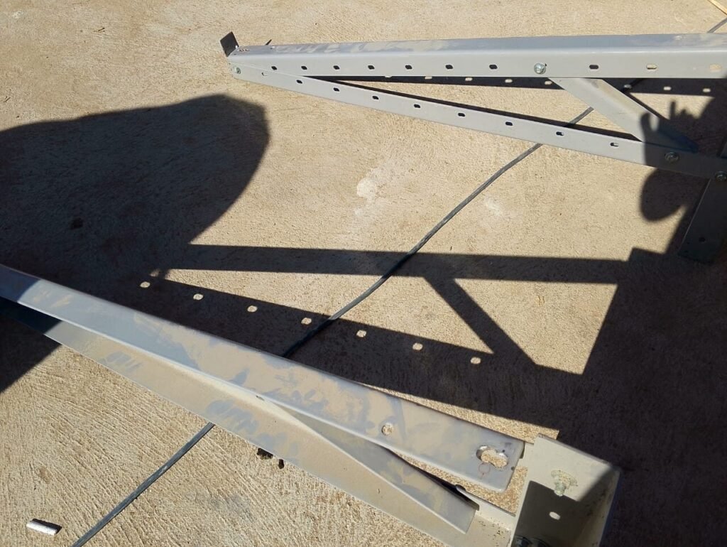 Mounting rails and brackets laid out on the ground ready to fix