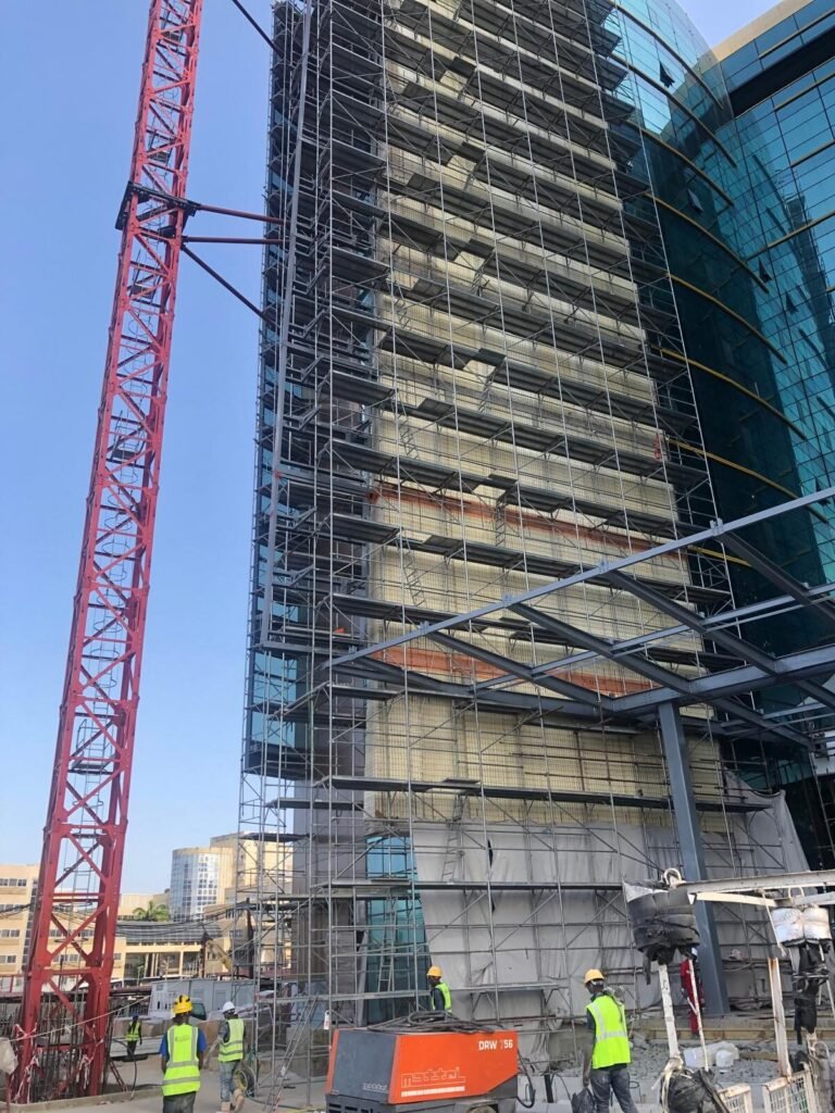 Scaffolding running the height of the tower with a tower crane alongside
