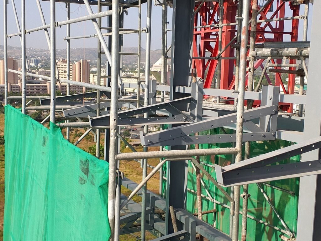 Safety netting and scaffolding across the structural frame