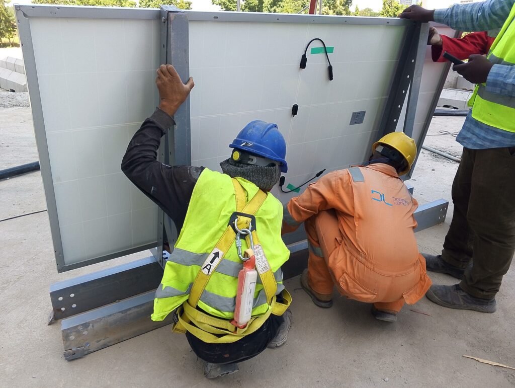 Two of the crew fitting a panel into its mounting frame