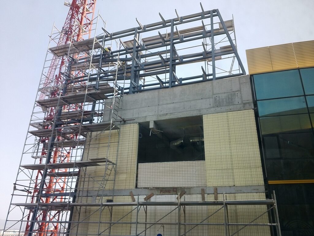 Building elevation wrapped in scaffolding during the installation