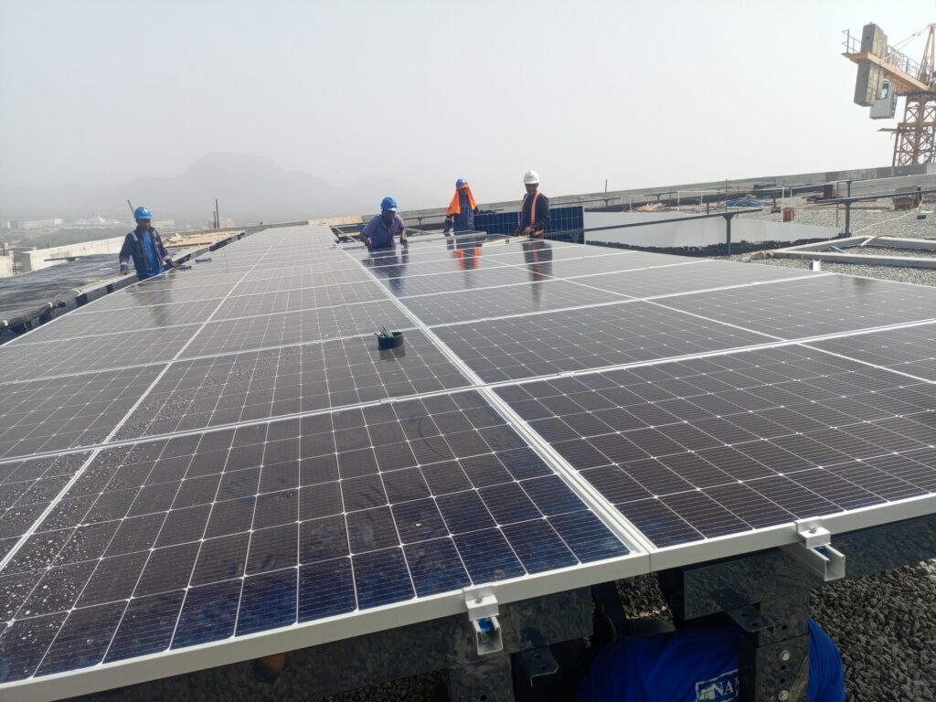 Completed rows of the rooftop array running back towards the hills