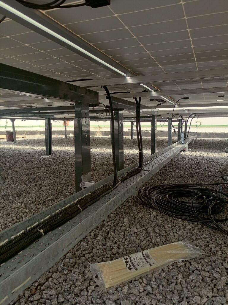 Underside of the array showing the mounting structure and DC cabling over the ballast