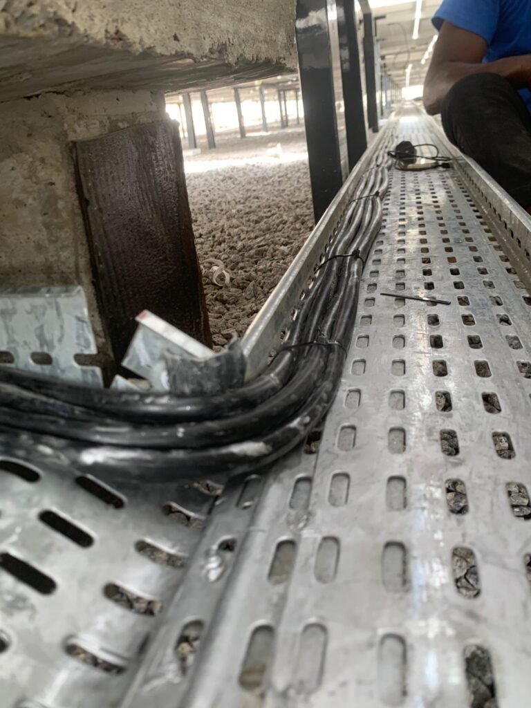 DC cabling routed and dressed into a perforated cable tray on the roof