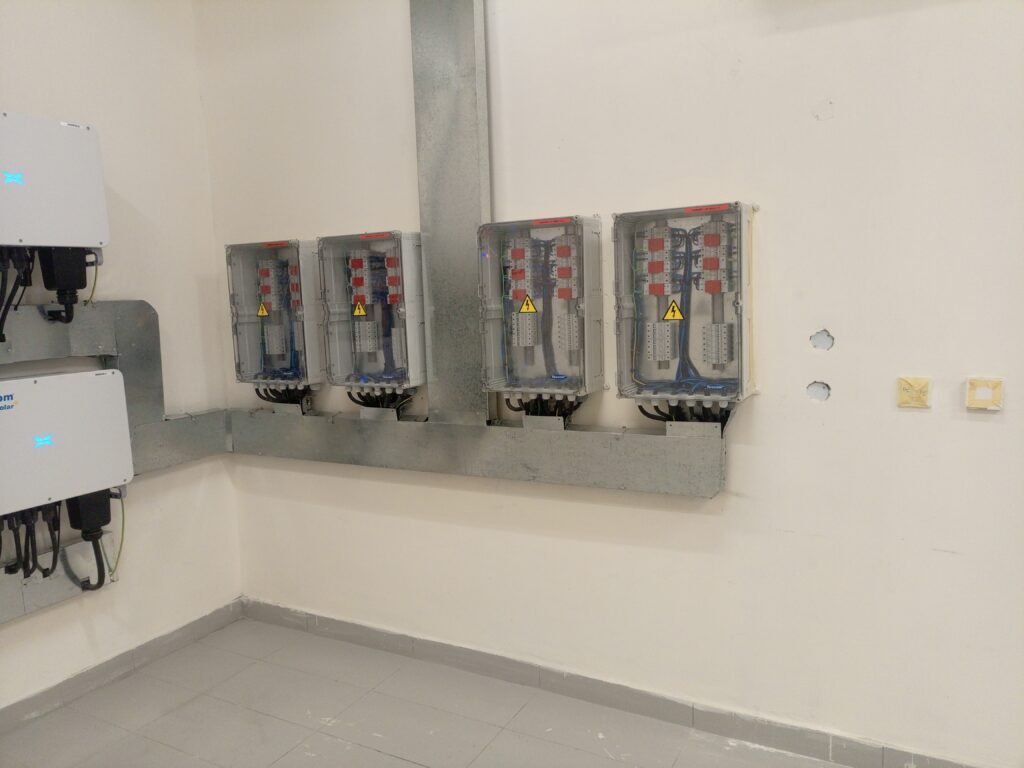 Row of DC isolators and protection switches on the plant room wall