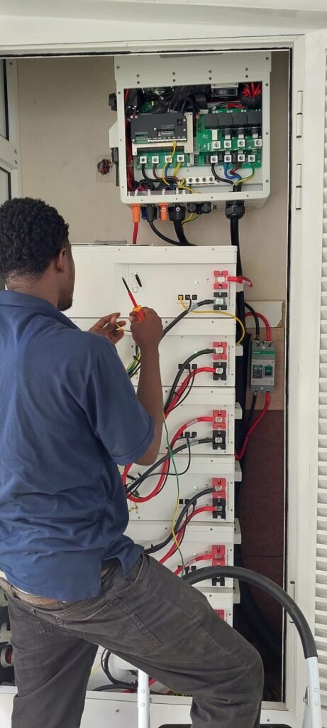 Engineer terminating cables inside an open distribution panel