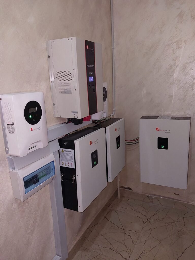 Residential plant room with three inverter and battery units side by side