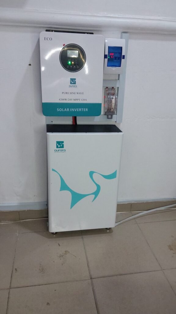 Wall-mounted inverter beside a matched floor-standing battery in a tiled room