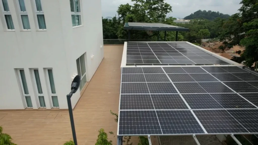 Rooftop array on a white building with forest behind